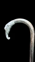 A walking stick with a silver knob shaped like an elephant's head.