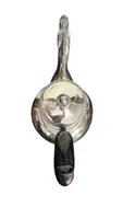 A silver coffee pot with a pear-shaped body on a circular base adorned with lanceolate leaves.