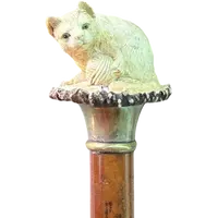 Walking stick with a deer antler knob depicting a cat playing with a ball of yarn.