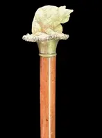 Walking stick with a deer antler knob depicting a cat playing with a ball of yarn.