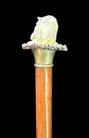 Walking stick with a deer antler knob depicting a cat playing with a ball of yarn.