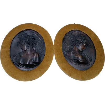Pair of Art Nouveau bronze reliefs depicting female faces