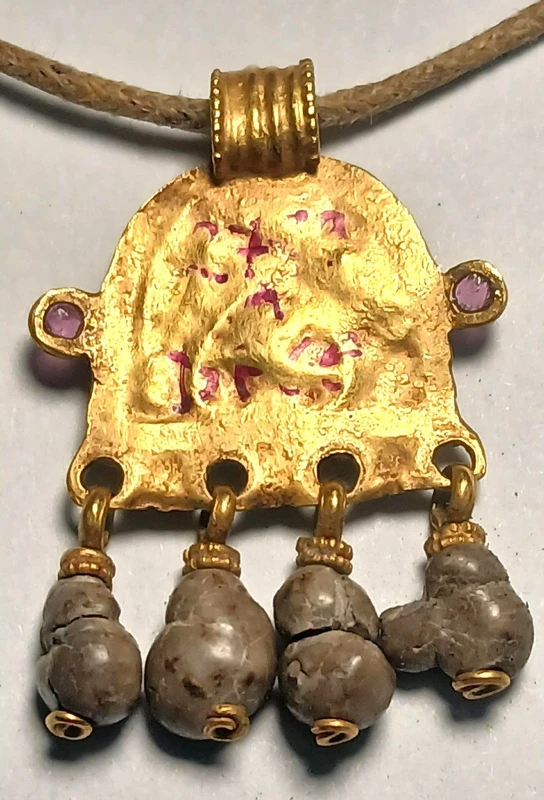 Byzantine magical amulet made of pure gold, rubies, glass paste, and 4 bezoars.