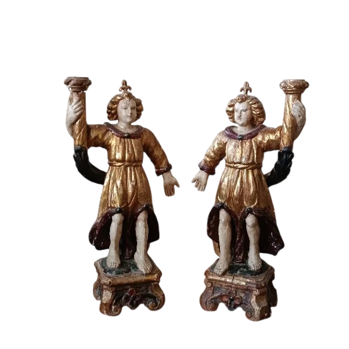 A pair of antique angel candlesticks, made of carved, lacquered, and gilded wood