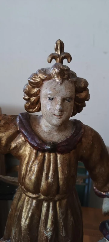 A pair of antique angel candlesticks, made of carved, lacquered, and gilded wood