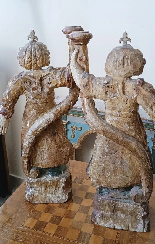 A pair of antique angel candlesticks, made of carved, lacquered, and gilded wood