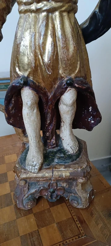 A pair of antique angel candlesticks, made of carved, lacquered, and gilded wood