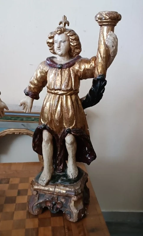 A pair of antique angel candlesticks, made of carved, lacquered, and gilded wood