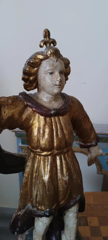 A pair of antique angel candlesticks, made of carved, lacquered, and gilded wood