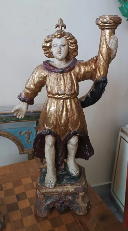 A pair of antique angel candlesticks, made of carved, lacquered, and gilded wood