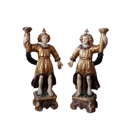 A pair of antique angel candlesticks, made of carved, lacquered, and gilded wood
