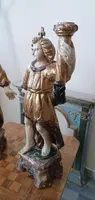 A pair of antique angel candlesticks, made of carved, lacquered, and gilded wood