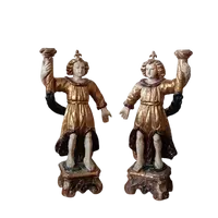 A pair of antique angel candlesticks, made of carved, lacquered, and gilded wood