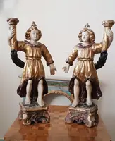 A pair of antique angel candlesticks, made of carved, lacquered, and gilded wood