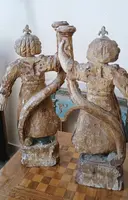 A pair of antique angel candlesticks, made of carved, lacquered, and gilded wood
