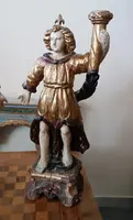 A pair of antique angel candlesticks, made of carved, lacquered, and gilded wood