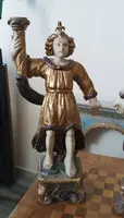 A pair of antique angel candlesticks, made of carved, lacquered, and gilded wood