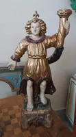 A pair of antique angel candlesticks, made of carved, lacquered, and gilded wood