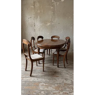 Oval walnut table and six matching chairs, early 20th century.