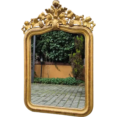 Antique gilded Piedmontese mirror with a carved cornice