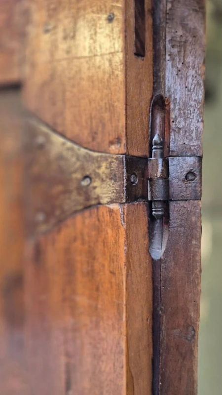 Antique 17th-century wardrobe from Parma, made of paneled and rusticated walnut