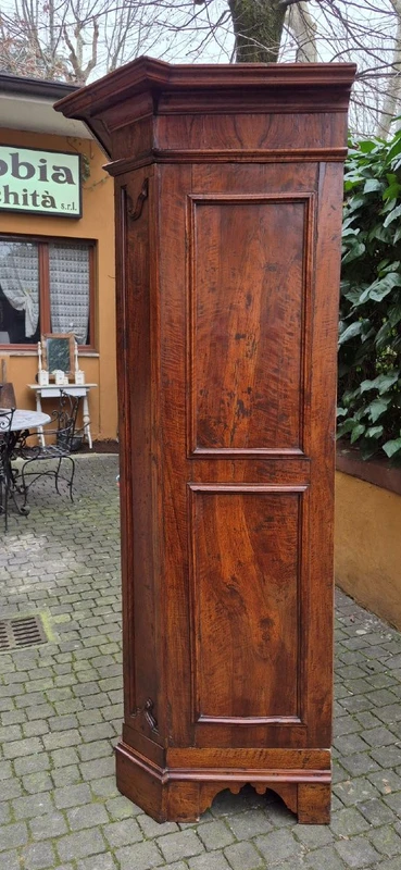 Antique 17th-century wardrobe from Parma, made of paneled and rusticated walnut