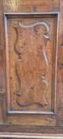 Antique 17th-century wardrobe from Parma, made of paneled and rusticated walnut