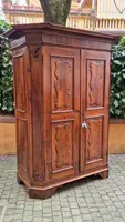 Antique 17th-century wardrobe from Parma, made of paneled and rusticated walnut