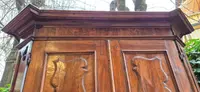 Antique 17th-century wardrobe from Parma, made of paneled and rusticated walnut