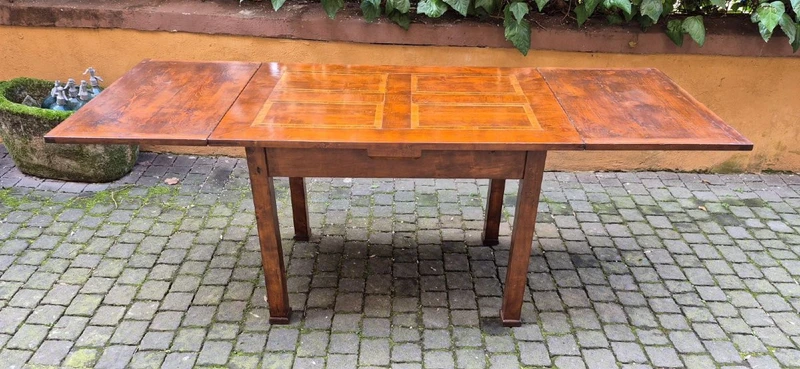 Antique extendable Empire-style table with a filleted tabletop
