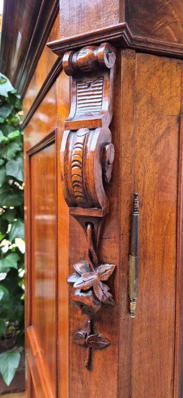 Antique Emilian walnut cabinet with carved garlands