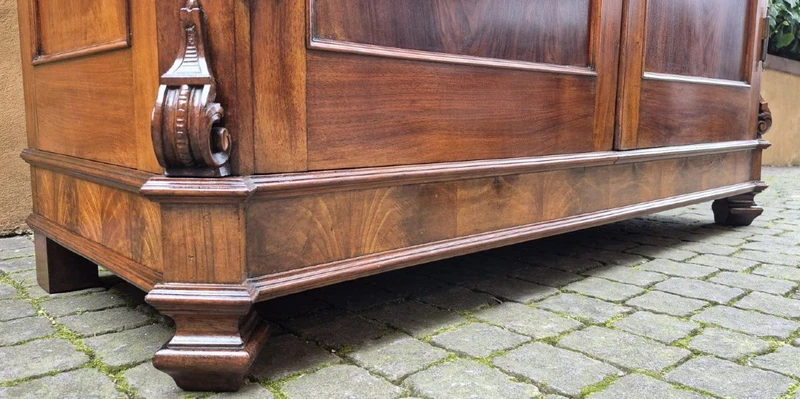 Antique Emilian walnut cabinet with carved garlands