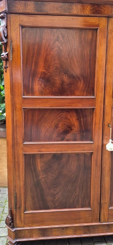 Antique Emilian walnut cabinet with carved garlands