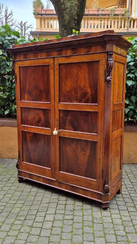 Antique Emilian walnut cabinet with carved garlands