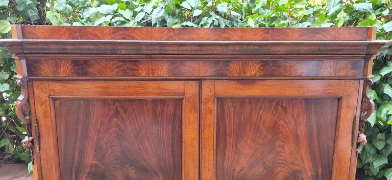 Antique Emilian walnut cabinet with carved garlands