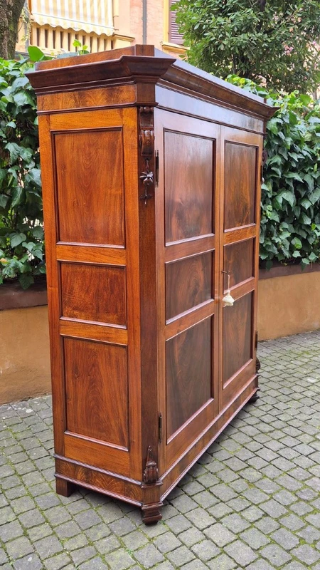Antique Emilian walnut cabinet with carved garlands