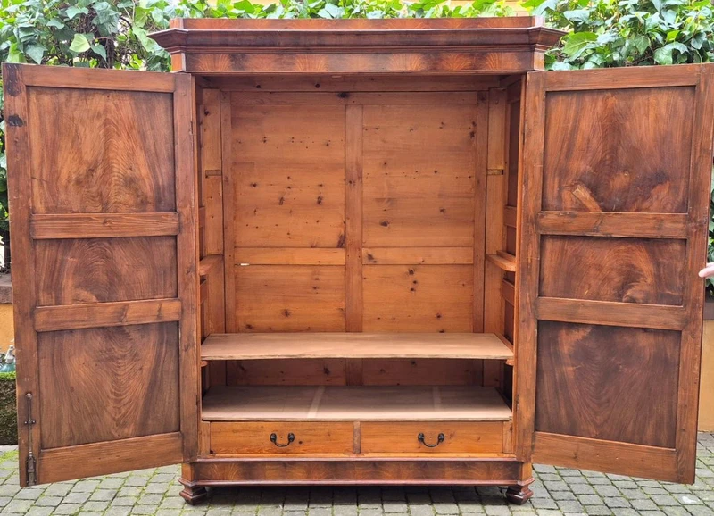 Antique Emilian walnut cabinet with carved garlands