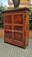Antique Emilian walnut cabinet with carved garlands