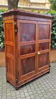 Antique Emilian walnut cabinet with carved garlands