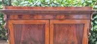 Antique Emilian walnut cabinet with carved garlands