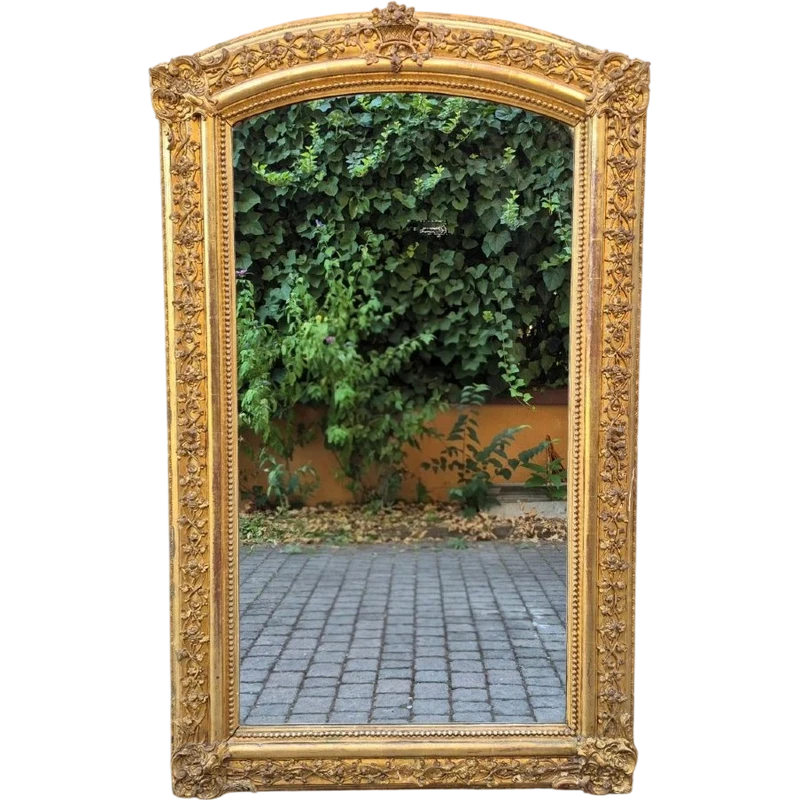 Antique gilded 19th-century mirror with an arched cornice