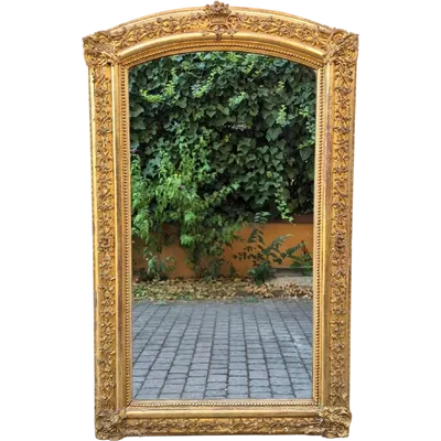 Antique gilded 19th-century mirror with an arched cornice