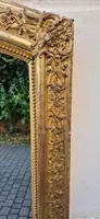 Antique gilded 19th-century mirror with an arched cornice