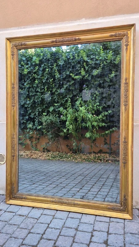 Antique gilded Empire-style mirror with a mercury mirror