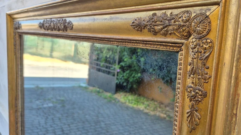 Antique gilded Empire-style mirror with a mercury mirror