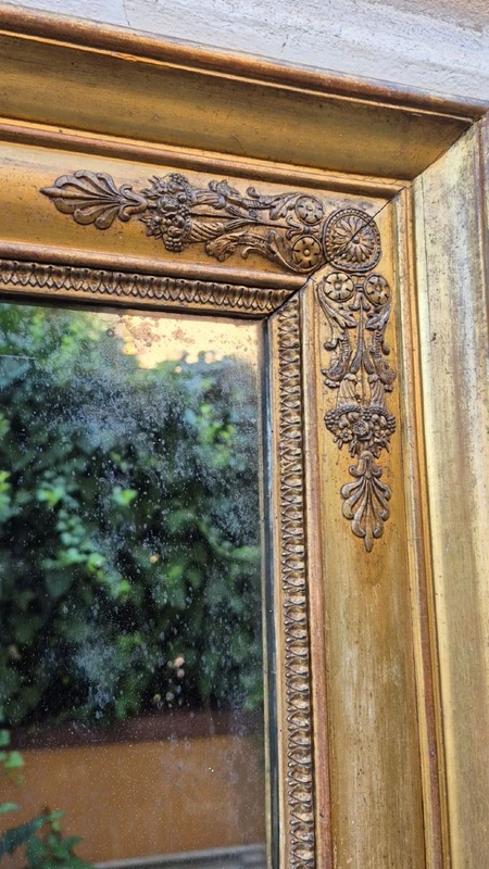 Antique gilded Empire-style mirror with a mercury mirror