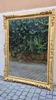 An antique Emilian mirror with openwork design, made of gilded wood, dating from the mid-19th century.