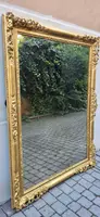 An antique Emilian mirror with openwork design, made of gilded wood, dating from the mid-19th century.