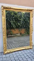 An antique Emilian mirror with openwork design, made of gilded wood, dating from the mid-19th century.