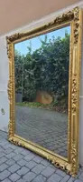 An antique Emilian mirror with openwork design, made of gilded wood, dating from the mid-19th century.